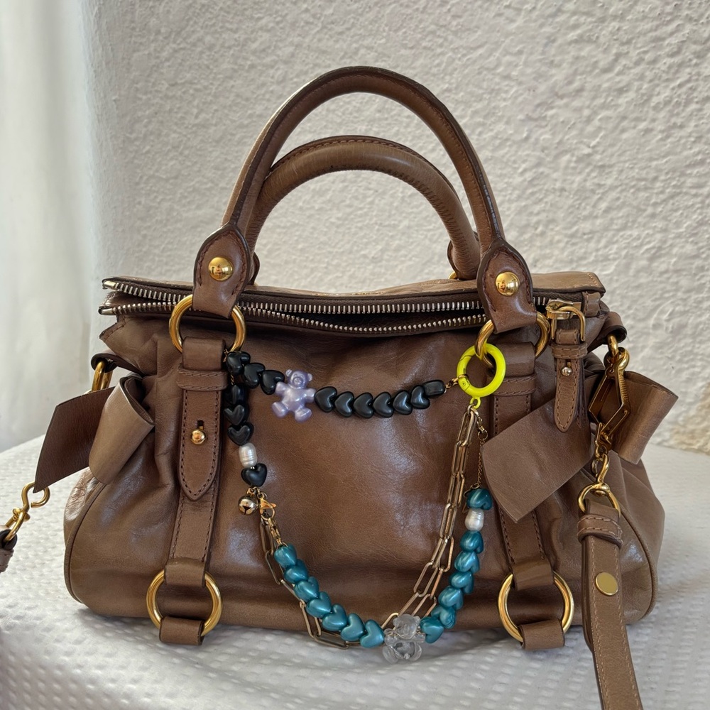Miu miu Mini Bow Bag in a tan color.